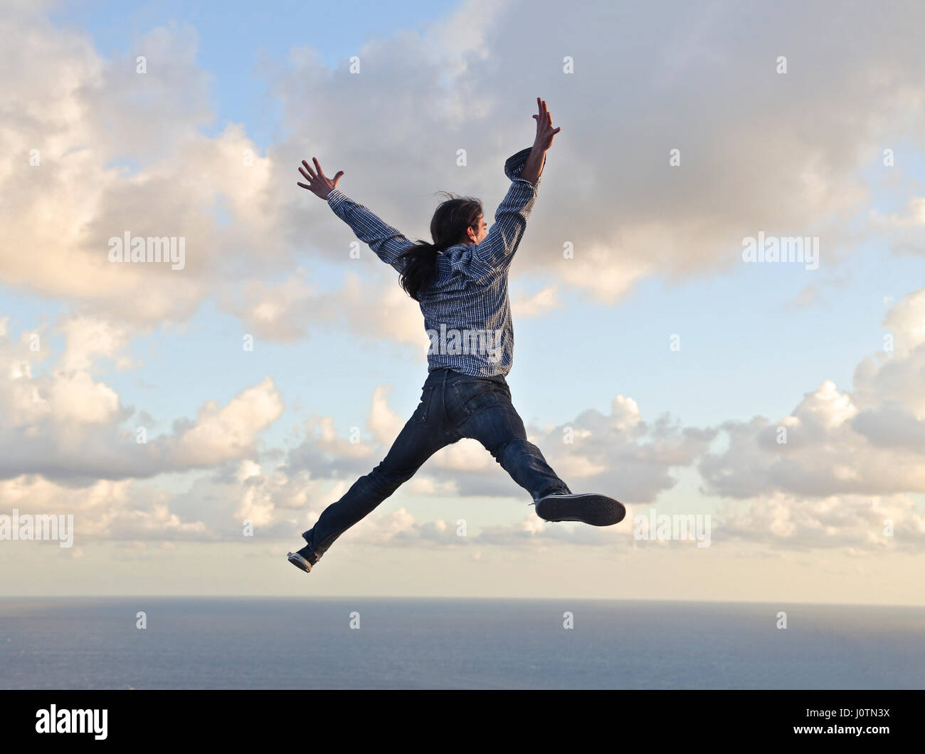 Man jumping in the sky Stock Photo
