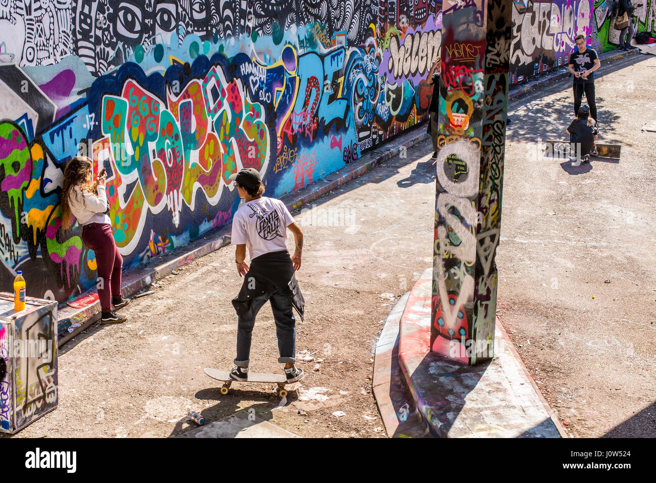 Teenager skater riding a skateboard in Leake Street tunnel, London, UK. Leake street also known as 'Graffiti Tunnel' or the 'Banksy Tunnel' is a road  Stock Photo