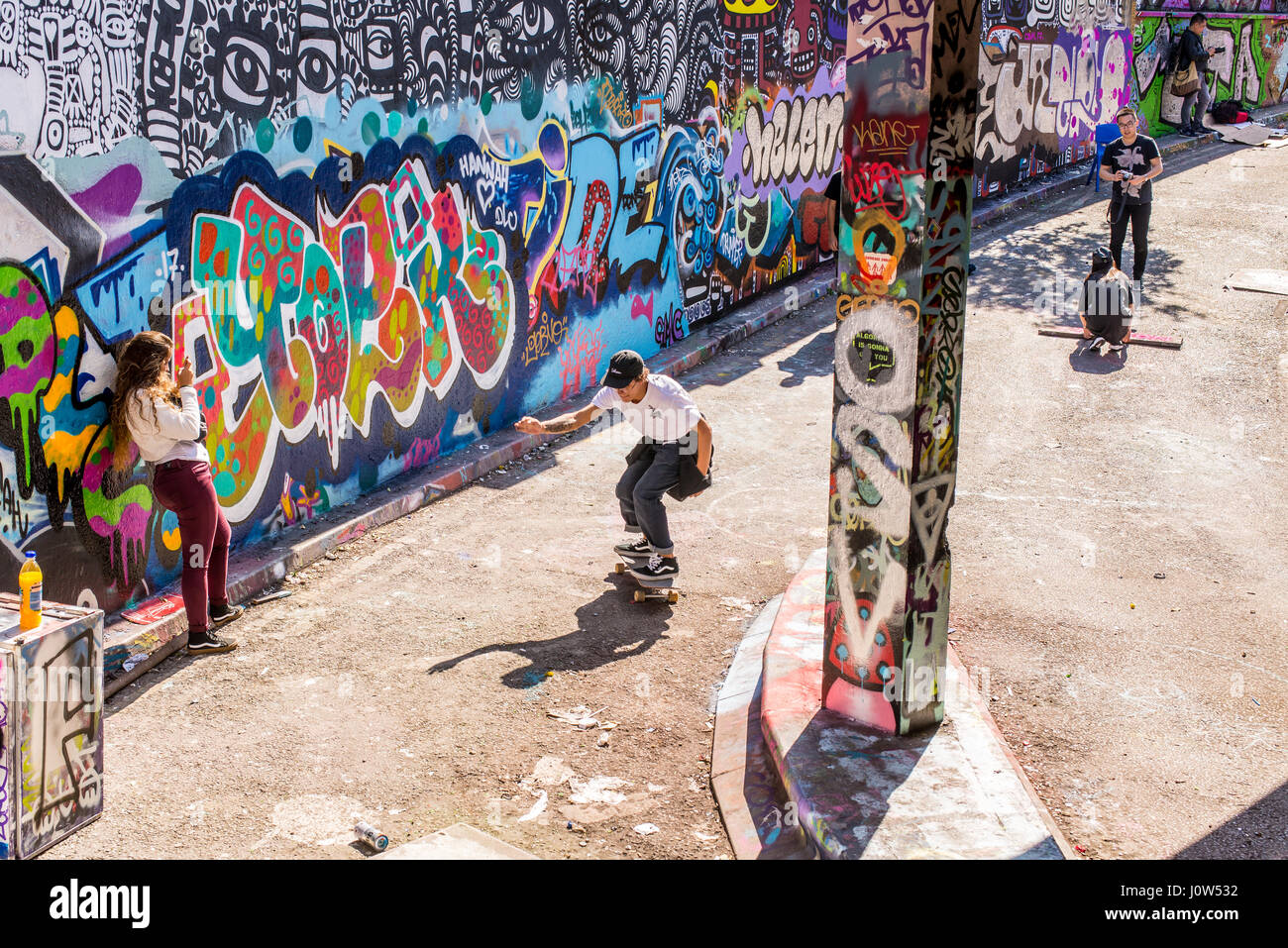 Teenager skater riding a skateboard in Leake Street tunnel, London, UK. Leake street also known as 'Graffiti Tunnel' or the 'Banksy Tunnel' is a road  Stock Photo