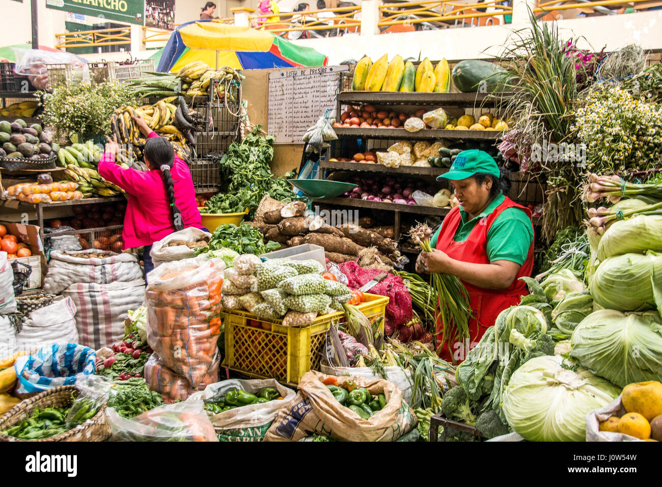 Woman selling vegtables, Otavalo, Ecuador, outdoor market.. Stock Photo