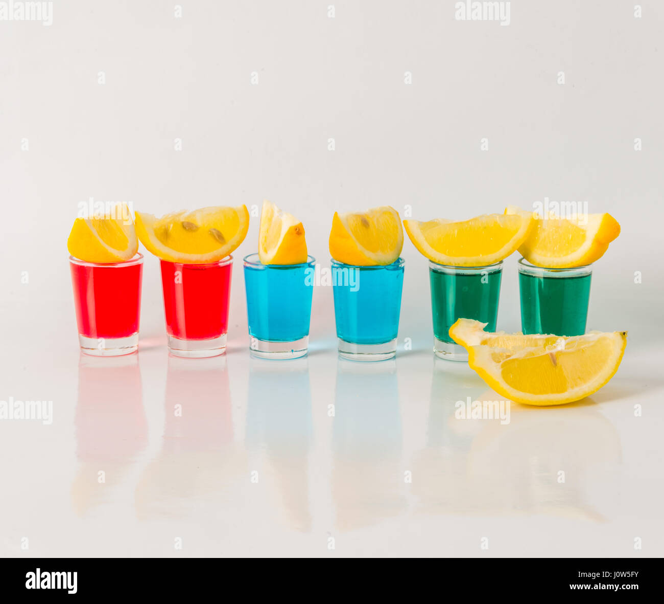 Glasses with blue, green and red kamikaze, glamorous drinks, mixed
