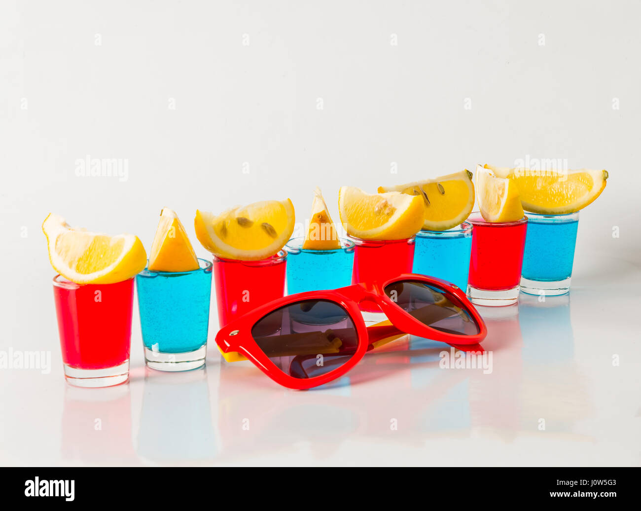 Glasses with blue, green and red kamikaze, glamorous drinks, mixed