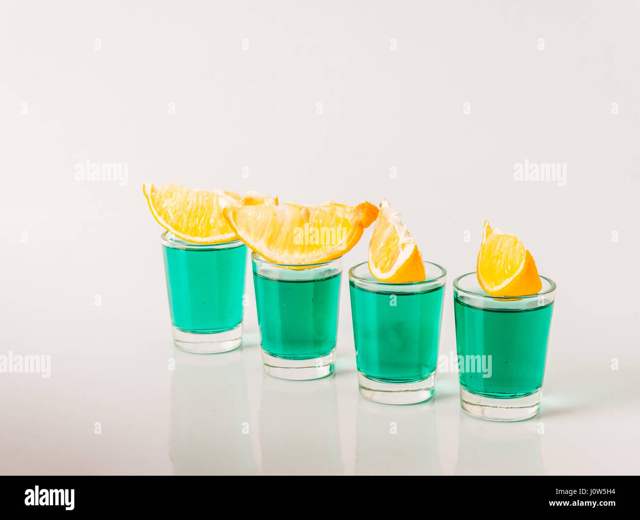 Glasses with green kamikaze, glamorous drinks, mixed drink poured into
