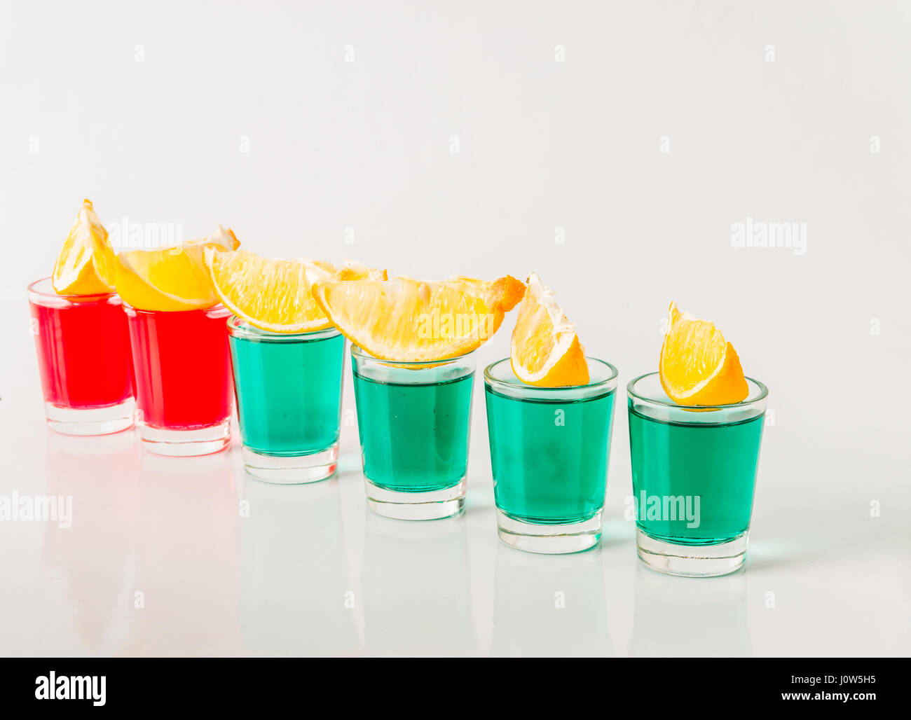 Glasses with green and red kamikaze, glamorous drinks, mixed drink