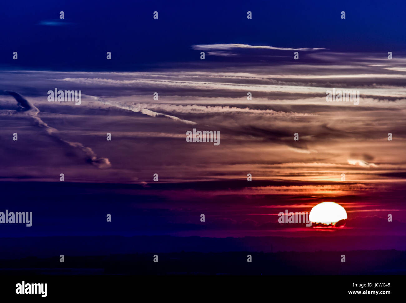 The setting sun Stock Photo - Alamy