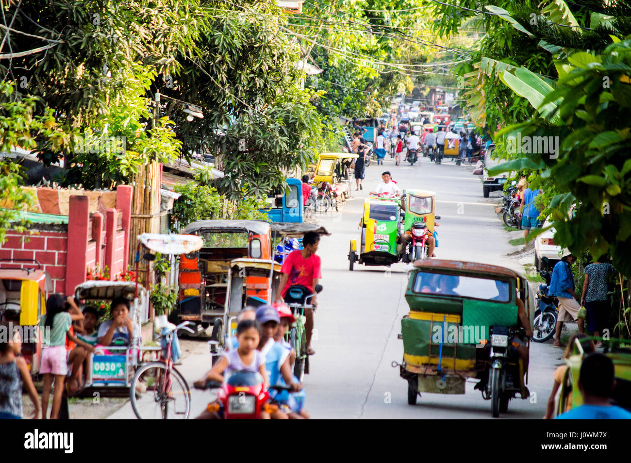 Tricycles, pedicabs and motor bikes along Gomez Street extension
