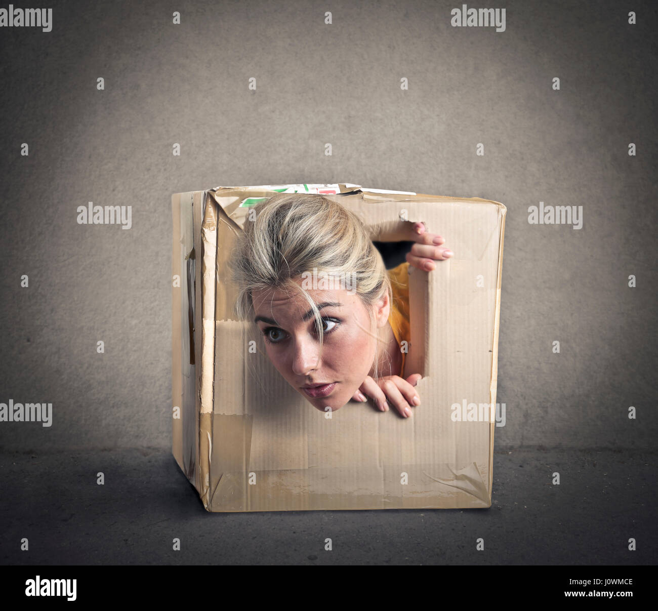 Woman in mini cardboard box Stock Photo - Alamy