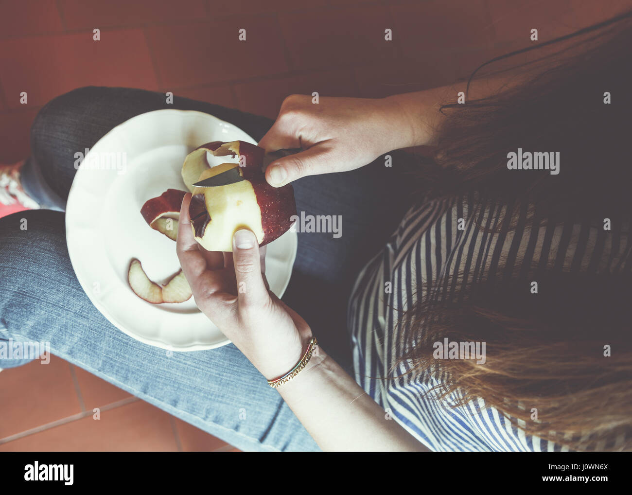 Girl peeling an apple Stock Photo
