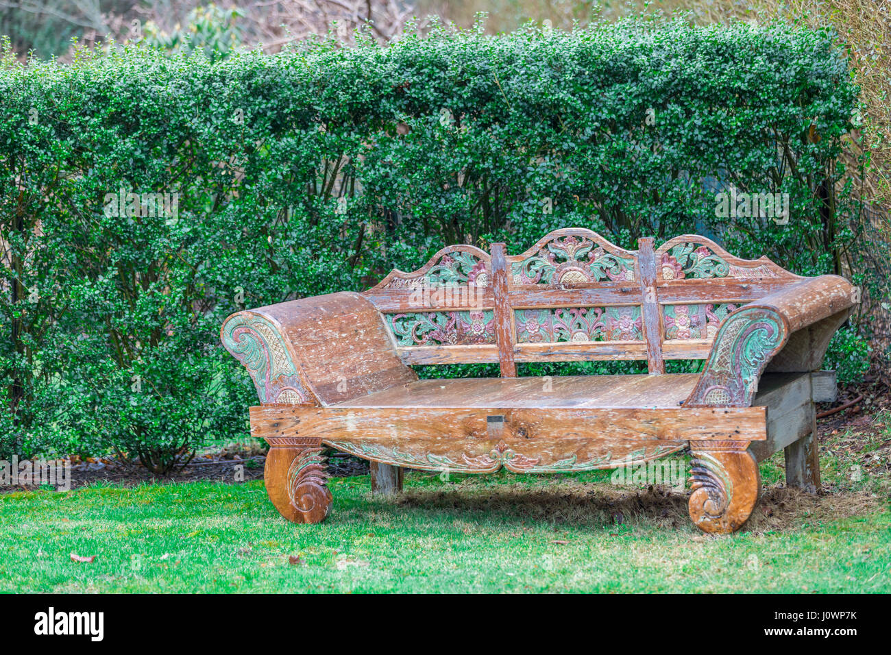 ornate decorative bench from the far east in a yard Stock Photo