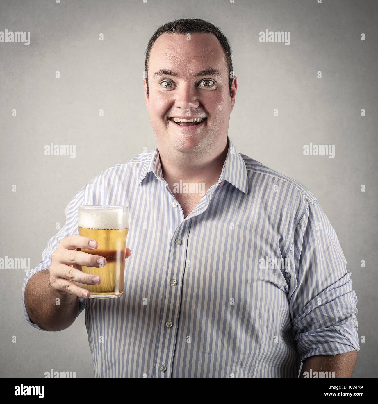 Happy fat man drinking beer Stock Photo Alamy