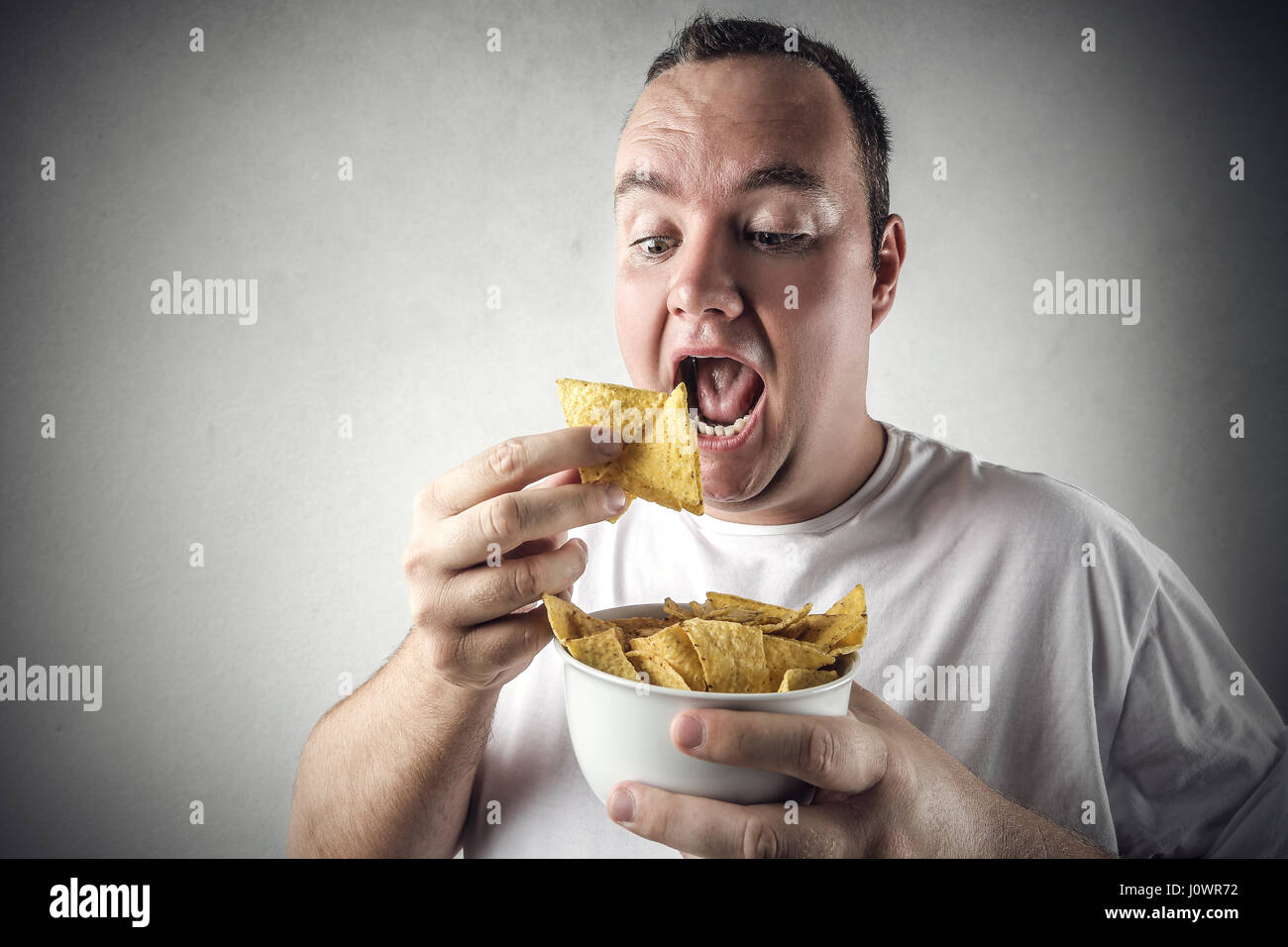 Man eating chips hi-res stock photography and images - Alamy
