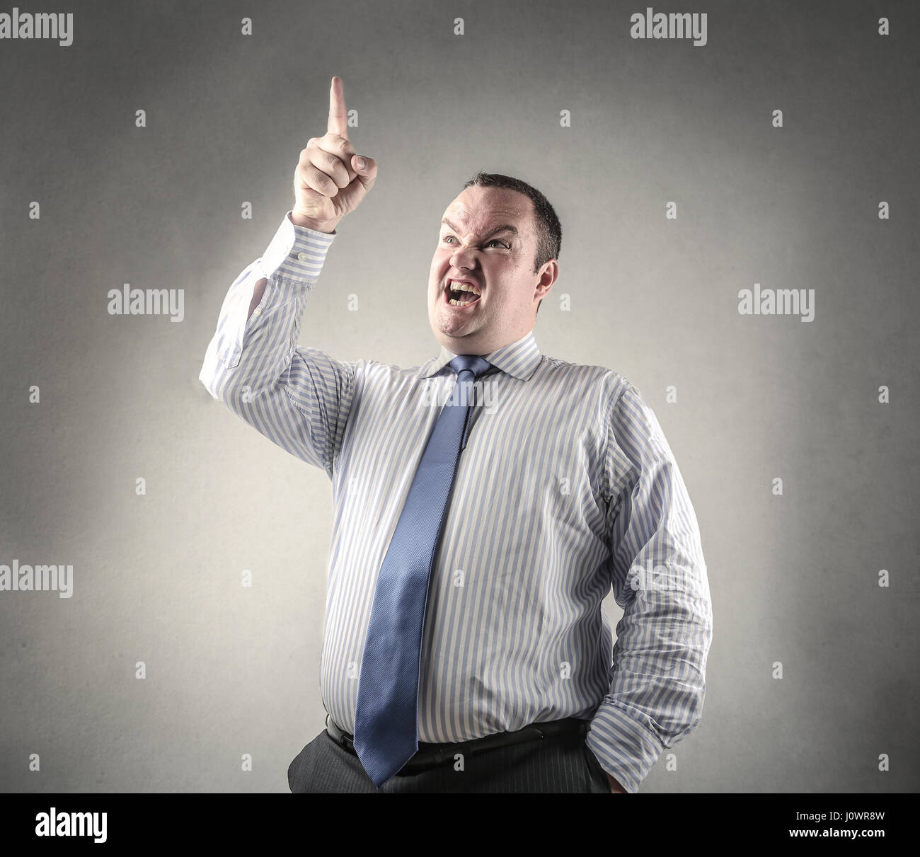 Businessman yelling and pointing upside Stock Photo