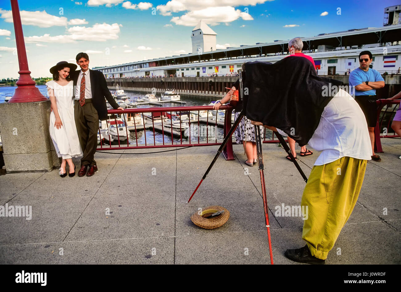A street photographer uses a vintage camera at the Old Port of Montreal City, Quebec, Canada. Stock Photo