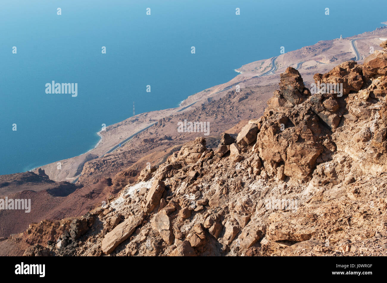 Rocky landscape and view of the Dead Sea, the salt lake with Earth's lowest elevation on land bordered by Jordan to east, Israel and Palestine to west Stock Photo