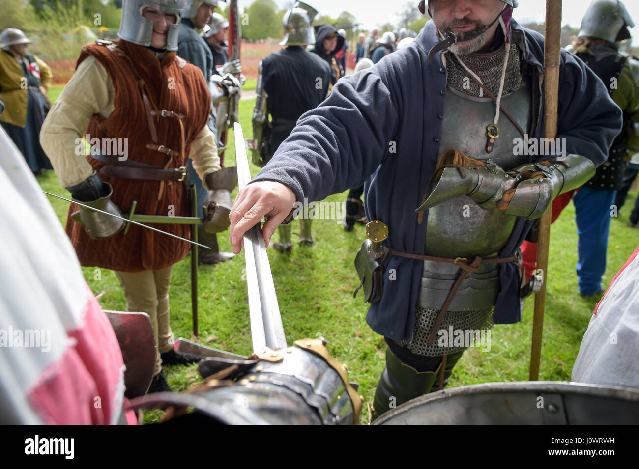 Weapons are safety checked for any sharp edges in preparation for a battle at the Glastonbury Medieval weekend, Glastonbury Abbey, in Somerset. Stock Photo