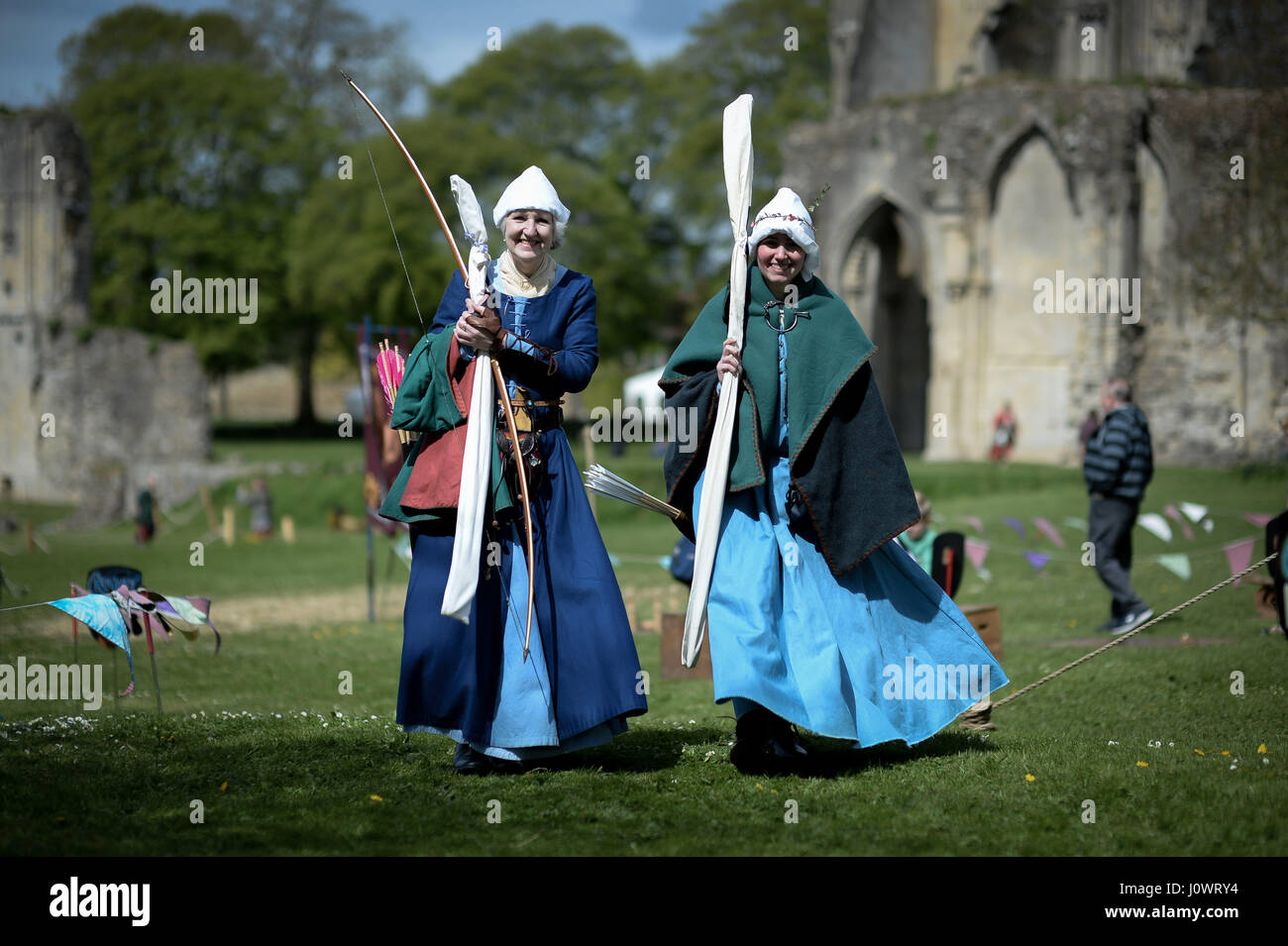 Women archers make their way from the target range at the Glastonbury Medieval weekend, Glastonbury Abbey, Somerset. Stock Photo