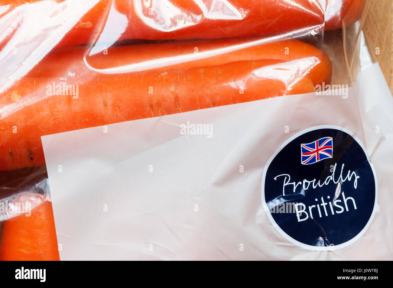 Proudly British label with Union Jack flag on a bag of carrots from Waitrose. Stock Photo