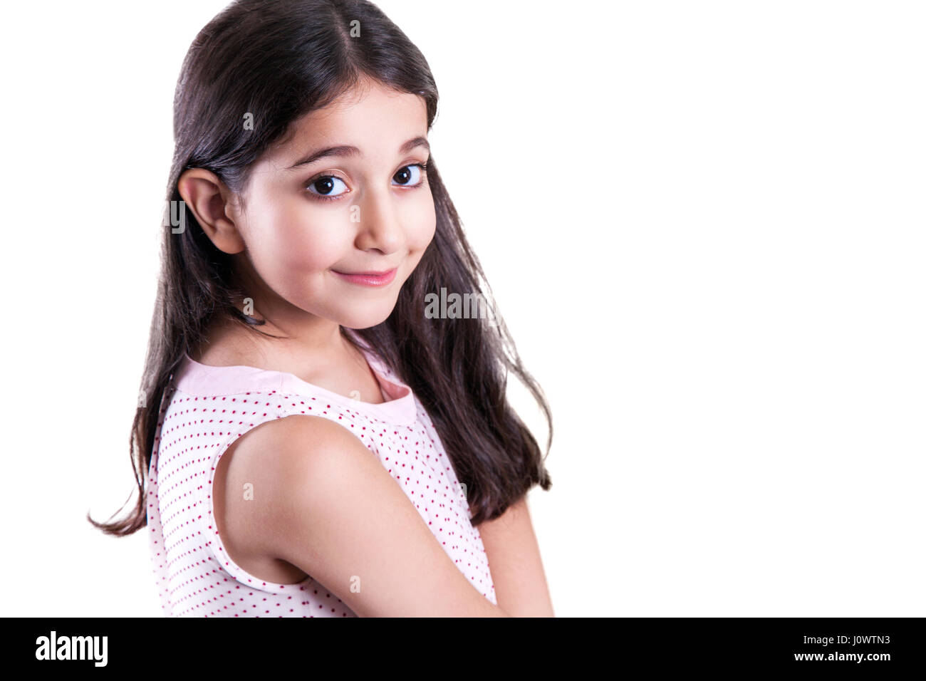 Beautiful happy little girl with long dark hair and dress looking at ...