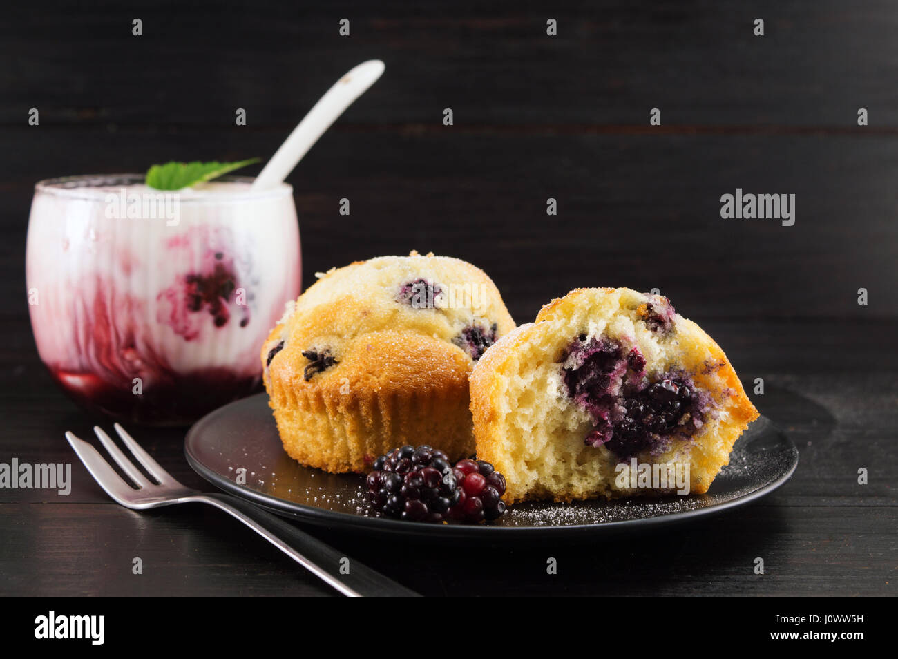 Homemade blackberry muffins covered with sugar powder Stock Photo