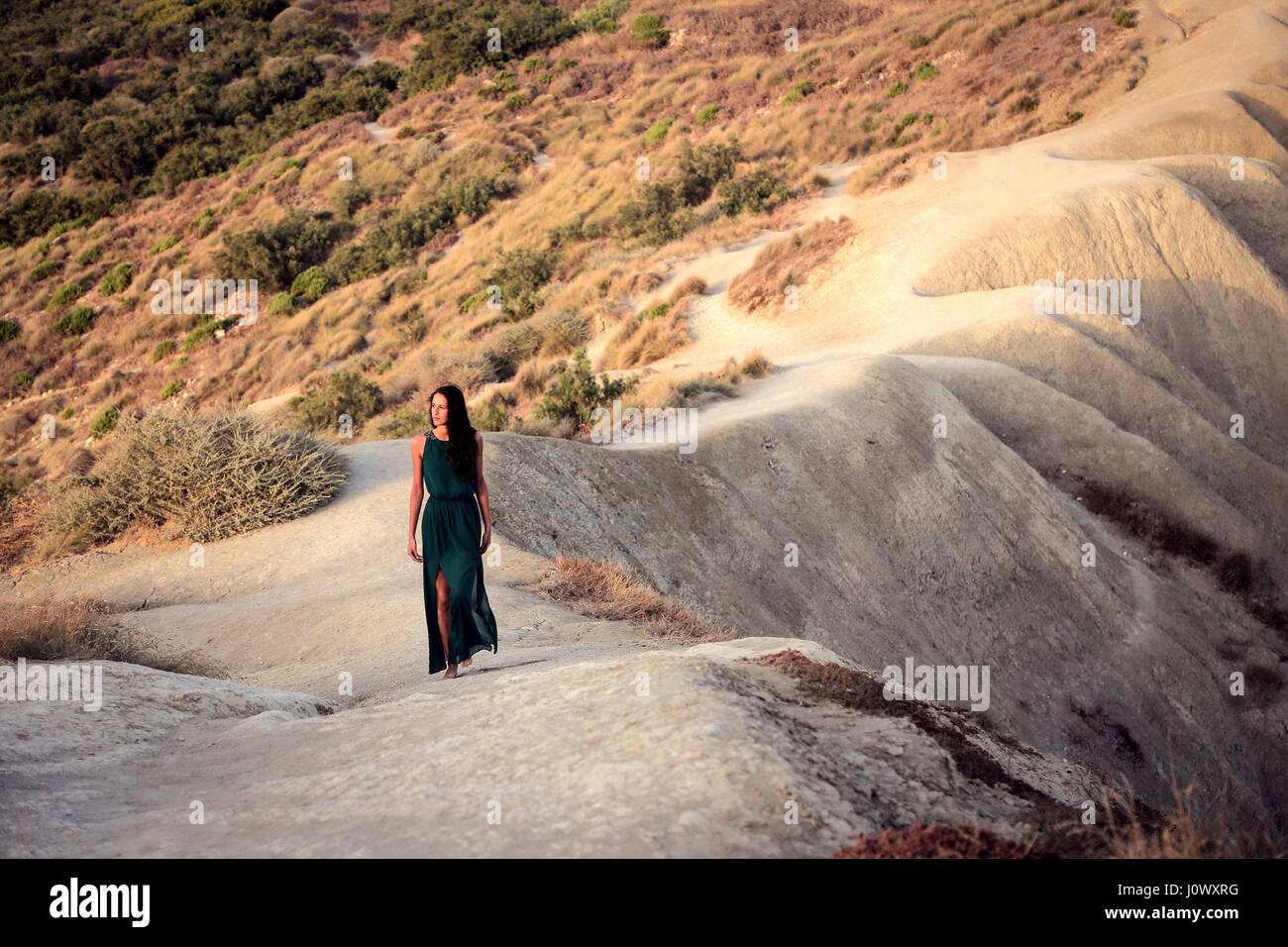 Woman in pretty dress walking on the beach Stock Photo - Alamy
