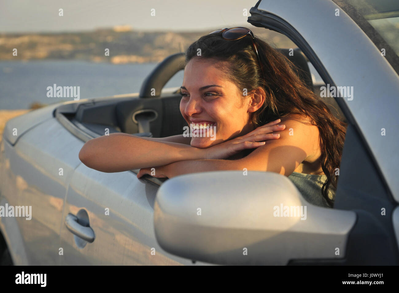 Brunette woman in car Stock Photo - Alamy