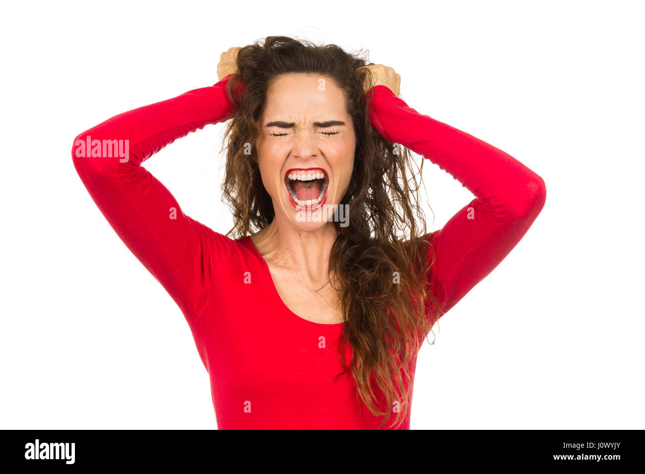 A very angry and frustrated woman is pulling her. Isolated on white. Stock Photo