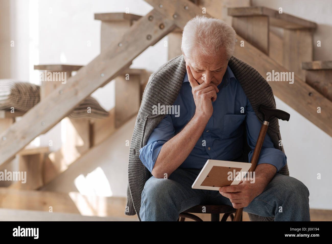 I Am So Alone Thoughtful Sad Nice Man Sitting Thoughtfully And Looking At The Photo While Missing His Wife Stock Photo Alamy