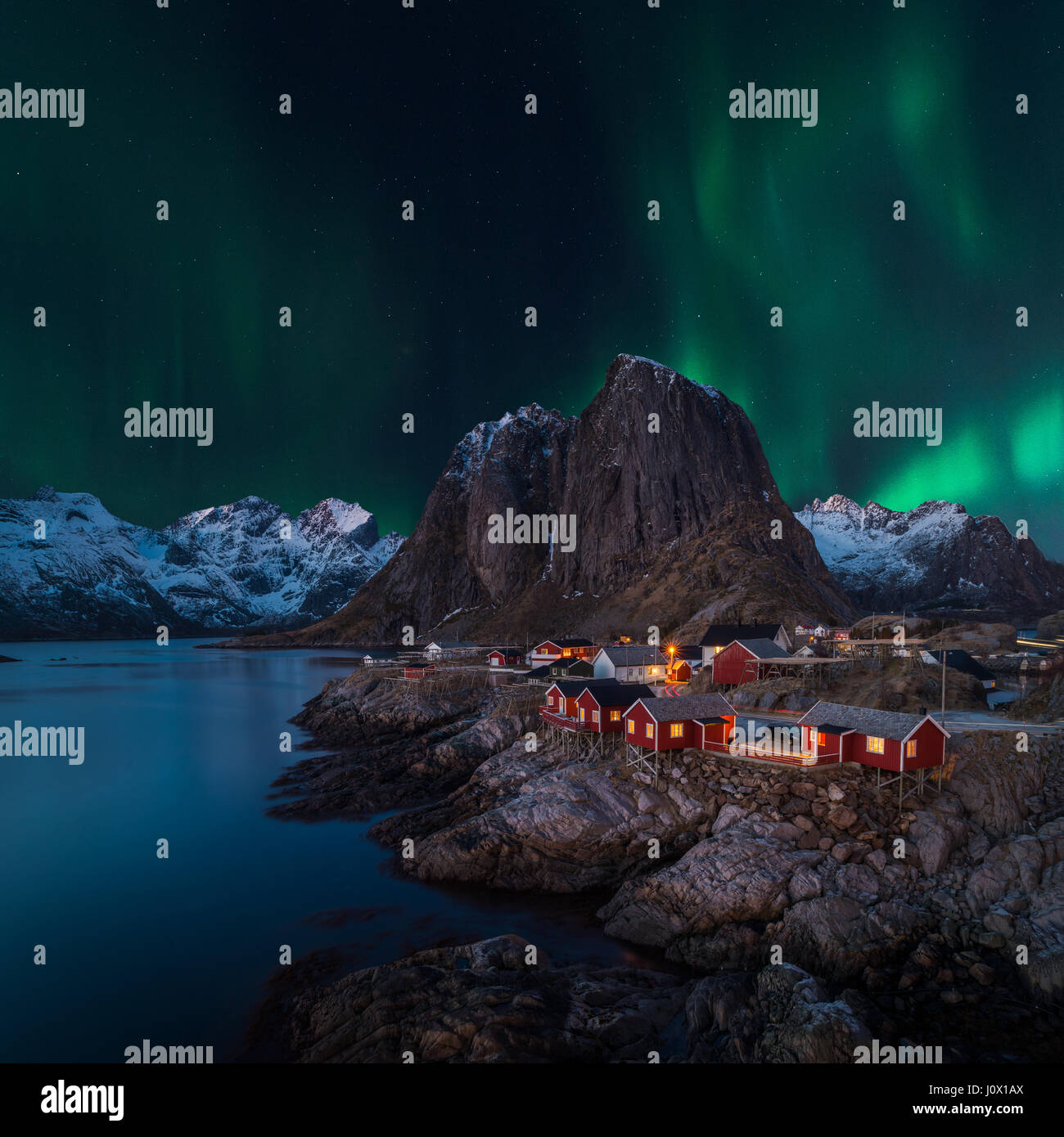 Northern lights over village, Lofoten, Nordland, Norway Stock Photo
