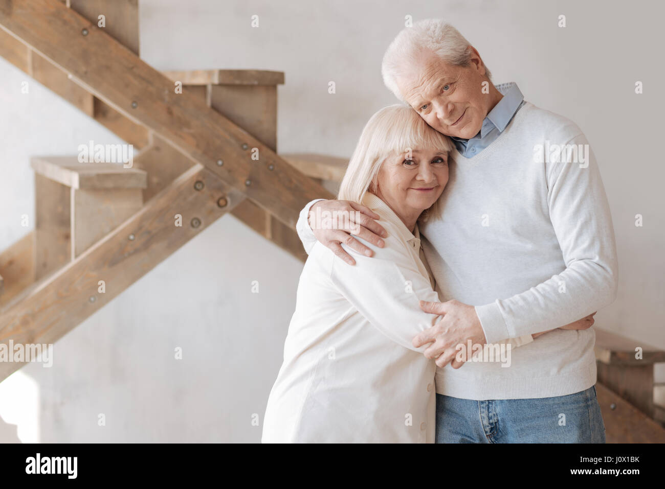 Delighted aged couple hugging each other Stock Photo
