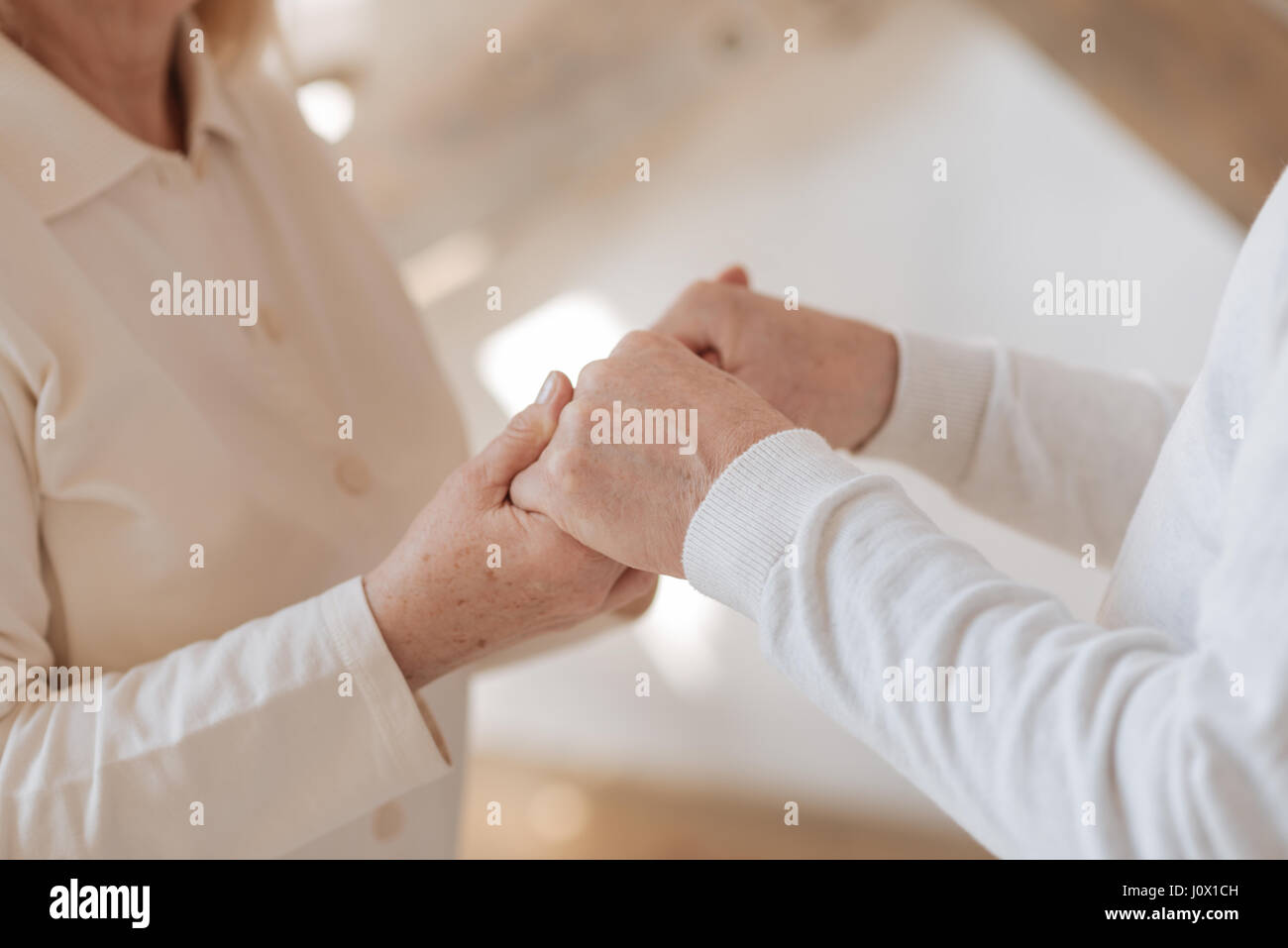 Close up of hands being held together Stock Photo