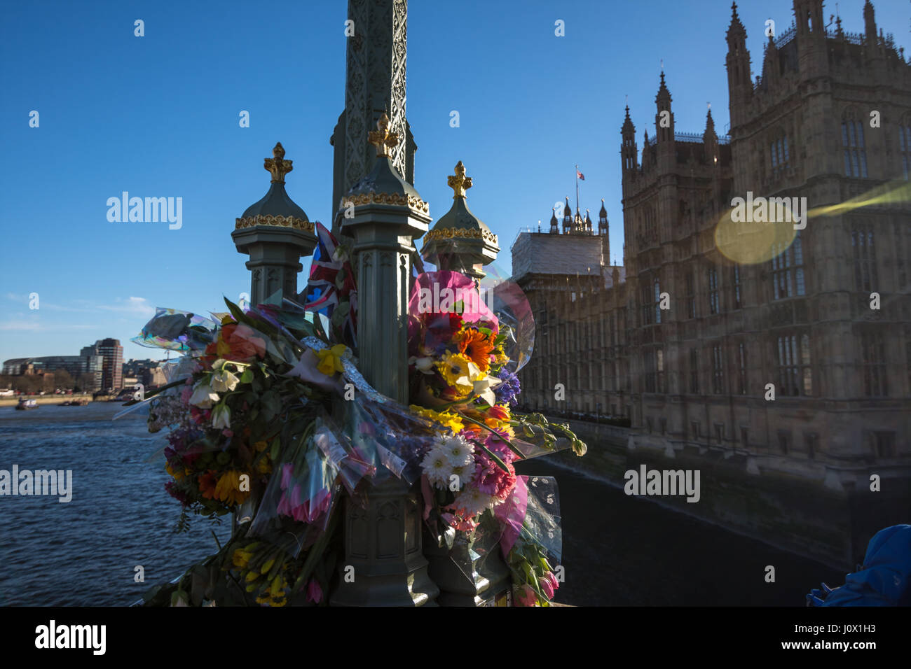 London, UK - March 25, 2017: Flower tributes for the victims of the March 22 terrorist attack at westminster bridge and british parliament Stock Photo