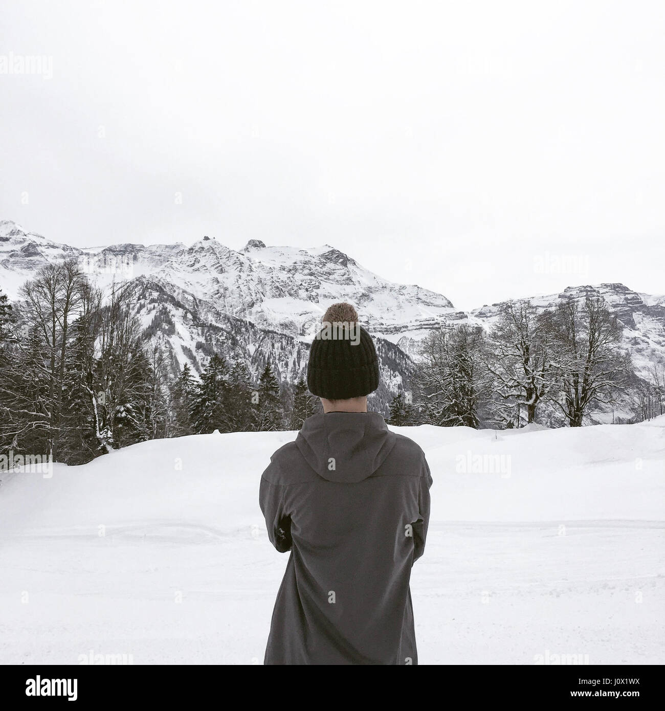 Rear view of boy looking at view, Alps, Braunwald, Switzerland Stock ...