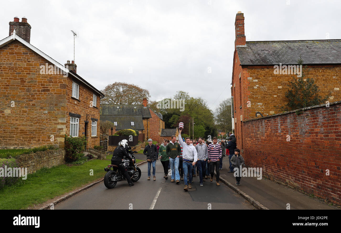 Villagers from Medbourne in Leicestershire parade a 'bottle' through the village before their annual bottle kicking match with neighbouring Hallaton. Stock Photo