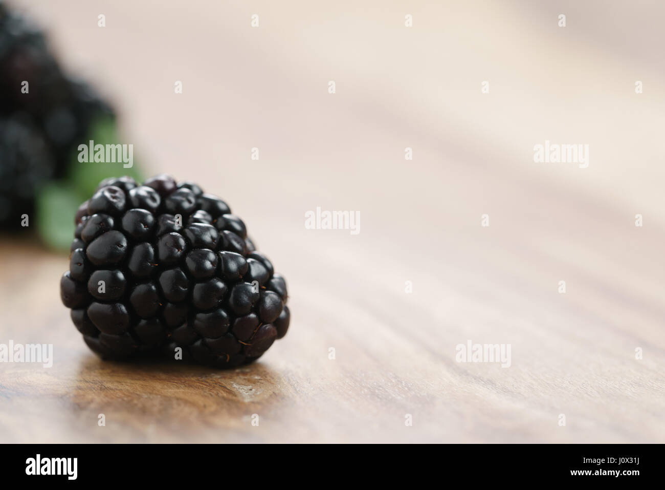 closeup photo of fresh blackberry on old wood table Stock Photo