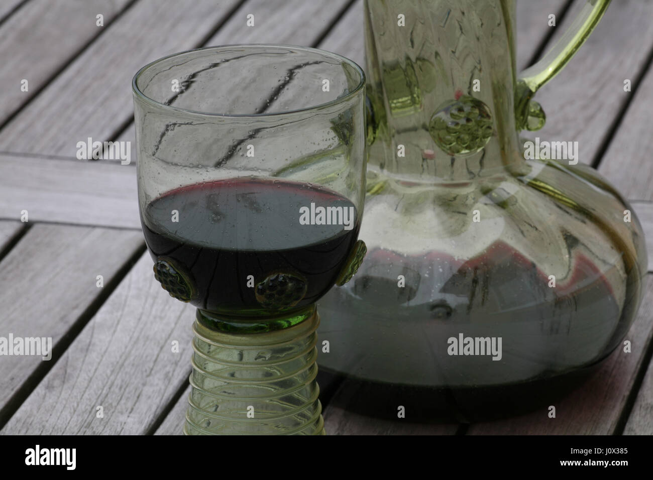 https://c8.alamy.com/comp/J0X385/hand-made-wine-glass-on-wooden-background-J0X385.jpg