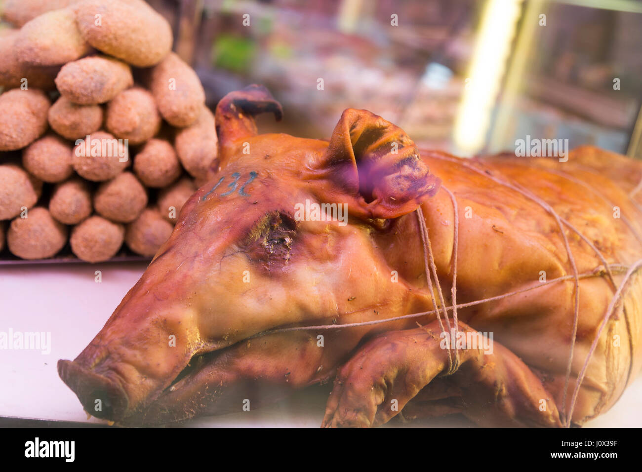 France, Nice, pig and sausages on sale in street shop window. Stock Photo