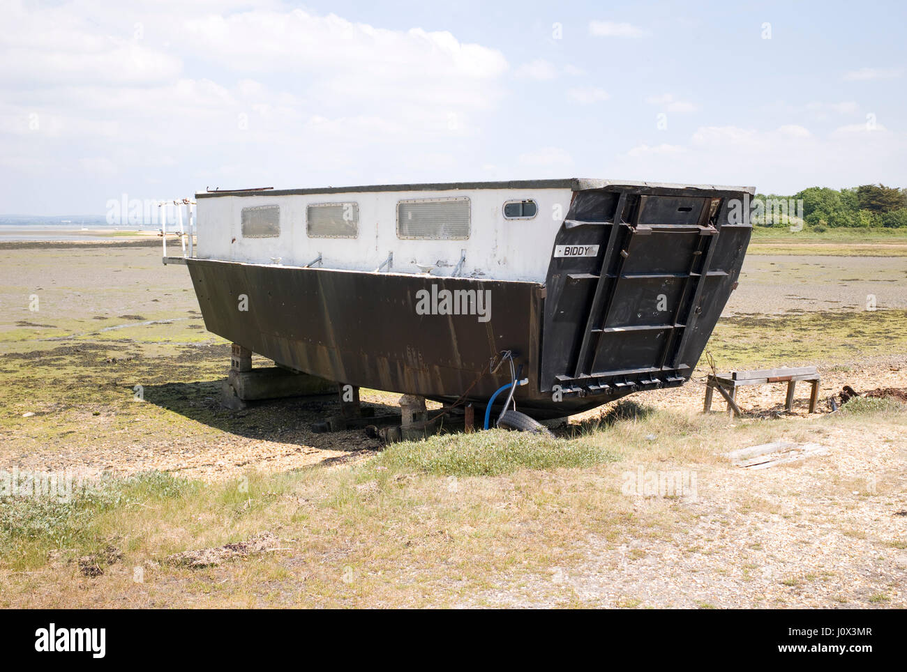 Second World War troop landing craft converted to a houseboat and moored on  the Kench on Hayling Island in Hampshire Stock Photo - Alamy