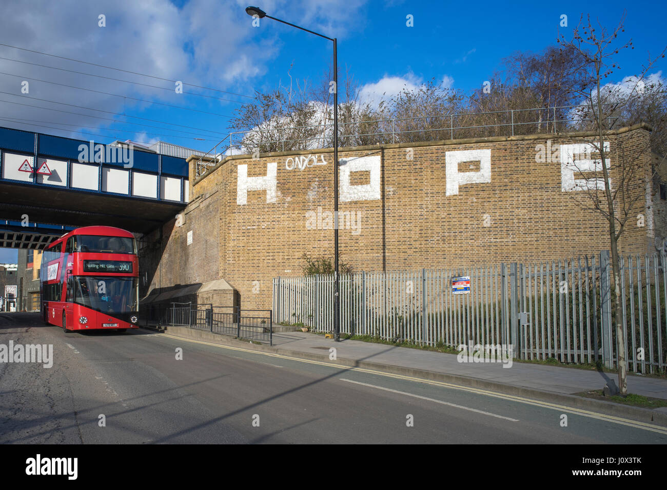 New London red Routemaster bus on York Way near King's Cross passing graffiti by Hope Stock Photo