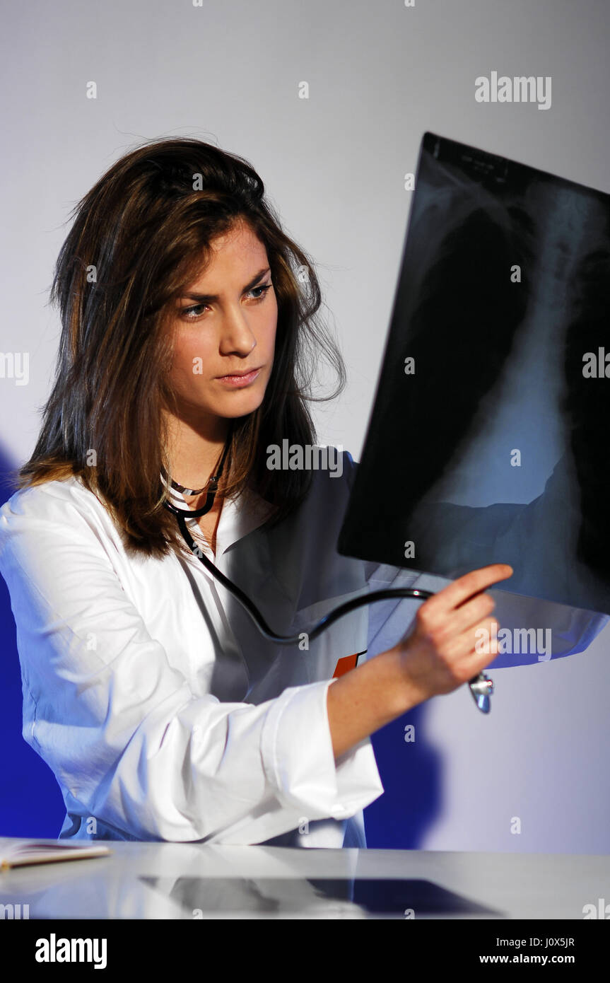 Concentrated female doctor looking at a x-ray Stock Photo
