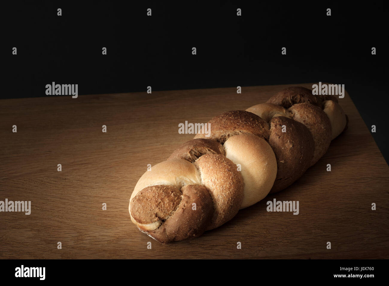 3 kinds interwoven bread lying on a wooden table Stock Photo