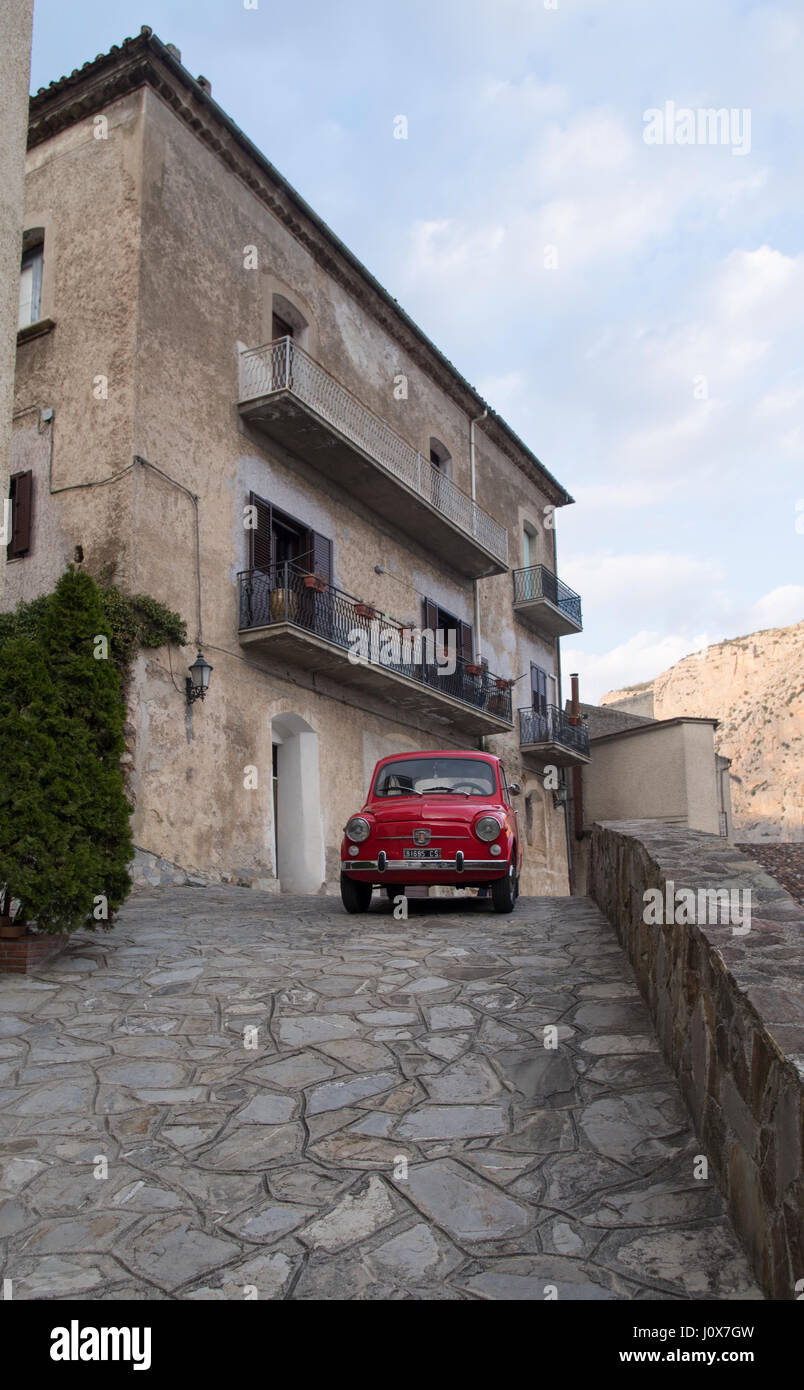 Red colored FIAT 500 parked in a street in Civita, Calabria region, Southern Italy Stock Photo