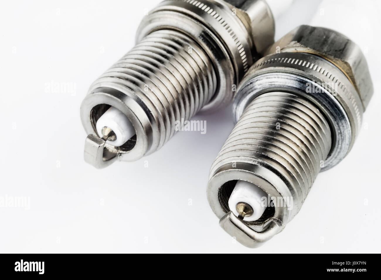 Spark plugs on a light background Stock Photo - Alamy