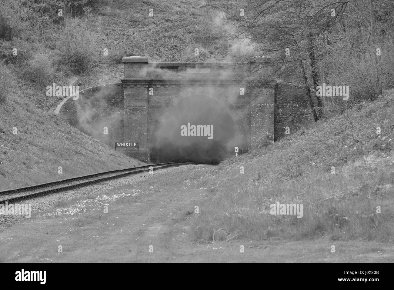 Smoke at the exit to a tunnel after a steam engine has been through it. Stock Photo