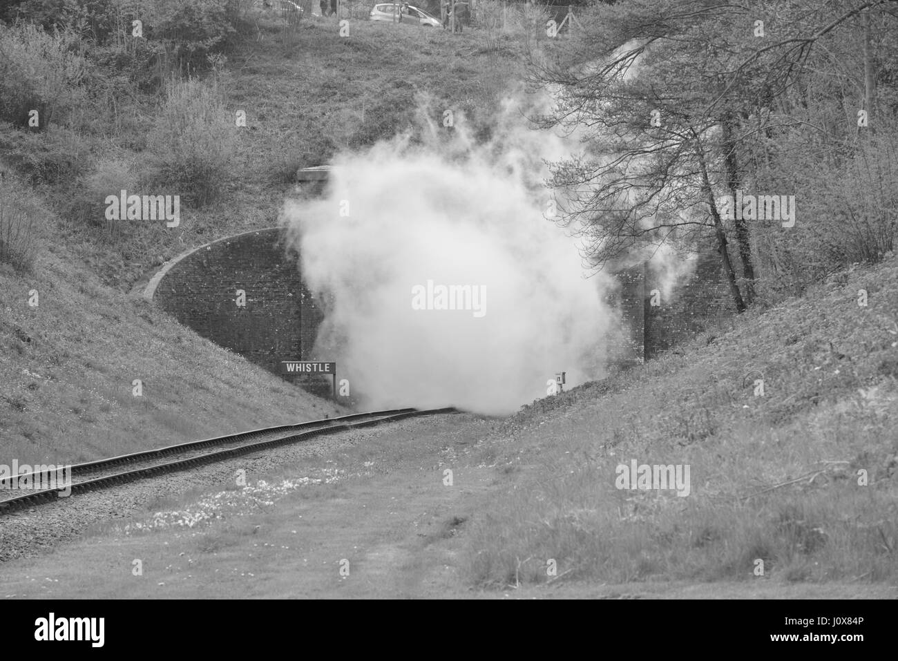 Smoke at the exit to a tunnel after a steam engine has been through it. Stock Photo