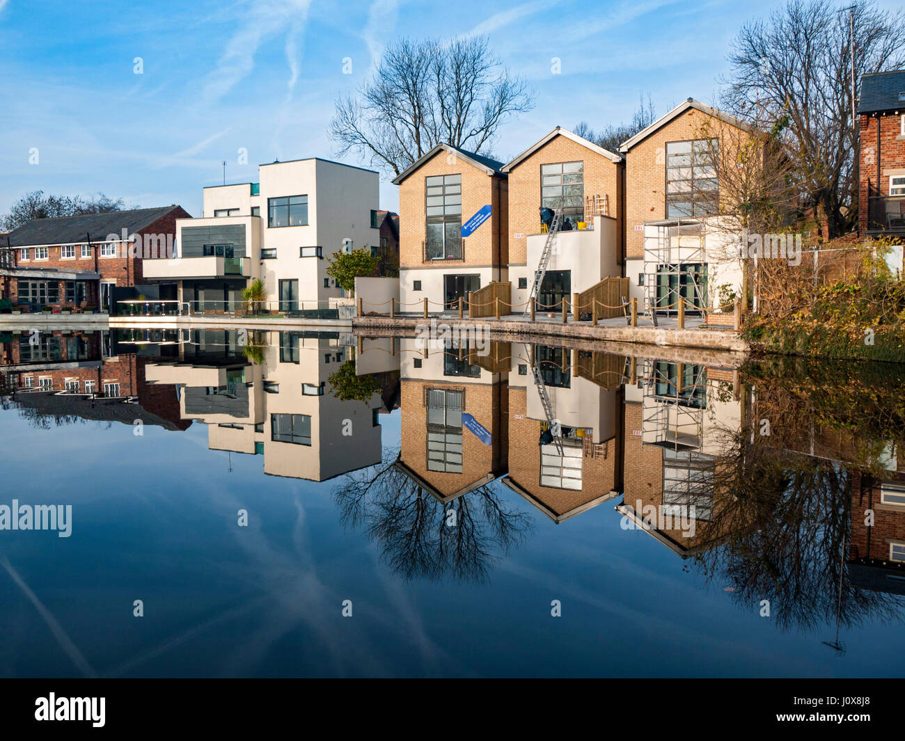 Canal side homes reflected in the Ashton Canal, Audenshaw, Tameside