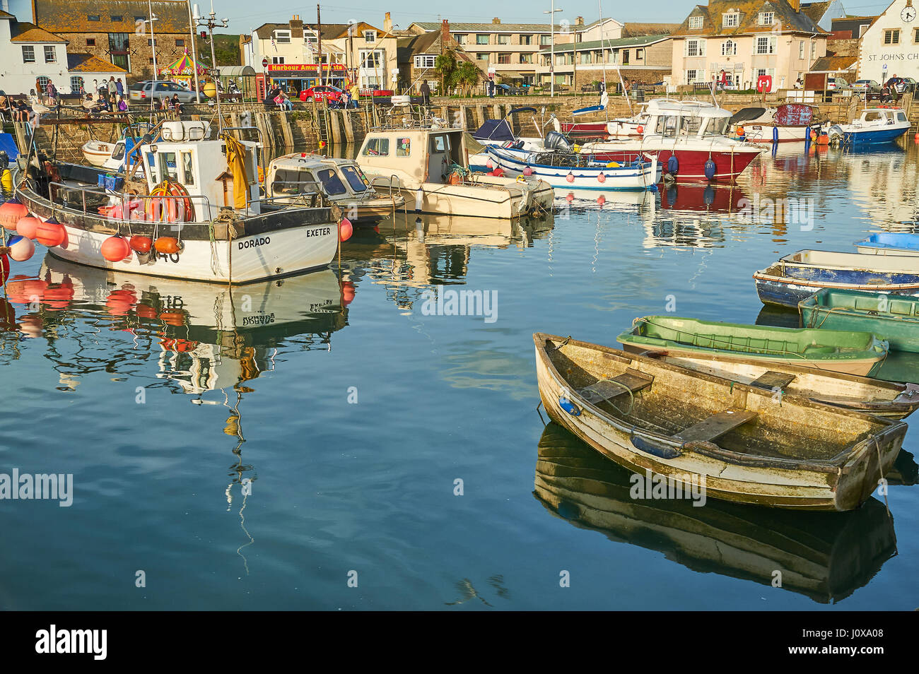 High tide, fishing boats and trawlers in the small seaside town of West Bay on Dorset's Jurassic Coast. Stock Photo