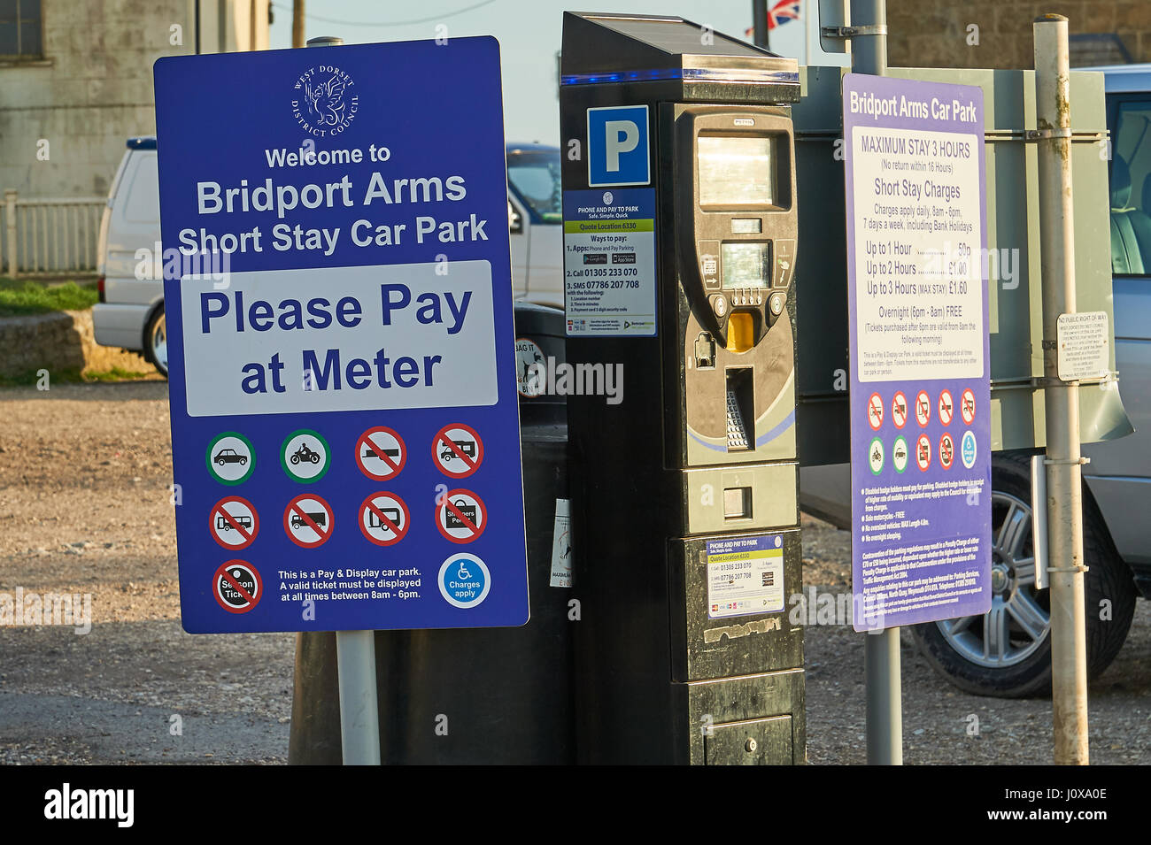 .Pay and Display car parking sign and ticket machine in West Bay, Dorset Stock Photo