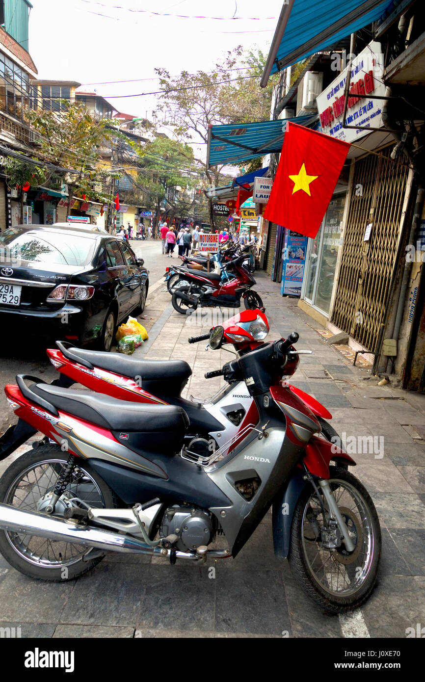 Vietnamese flag flies outside every building by Vietnamese Government decree Stock Photo