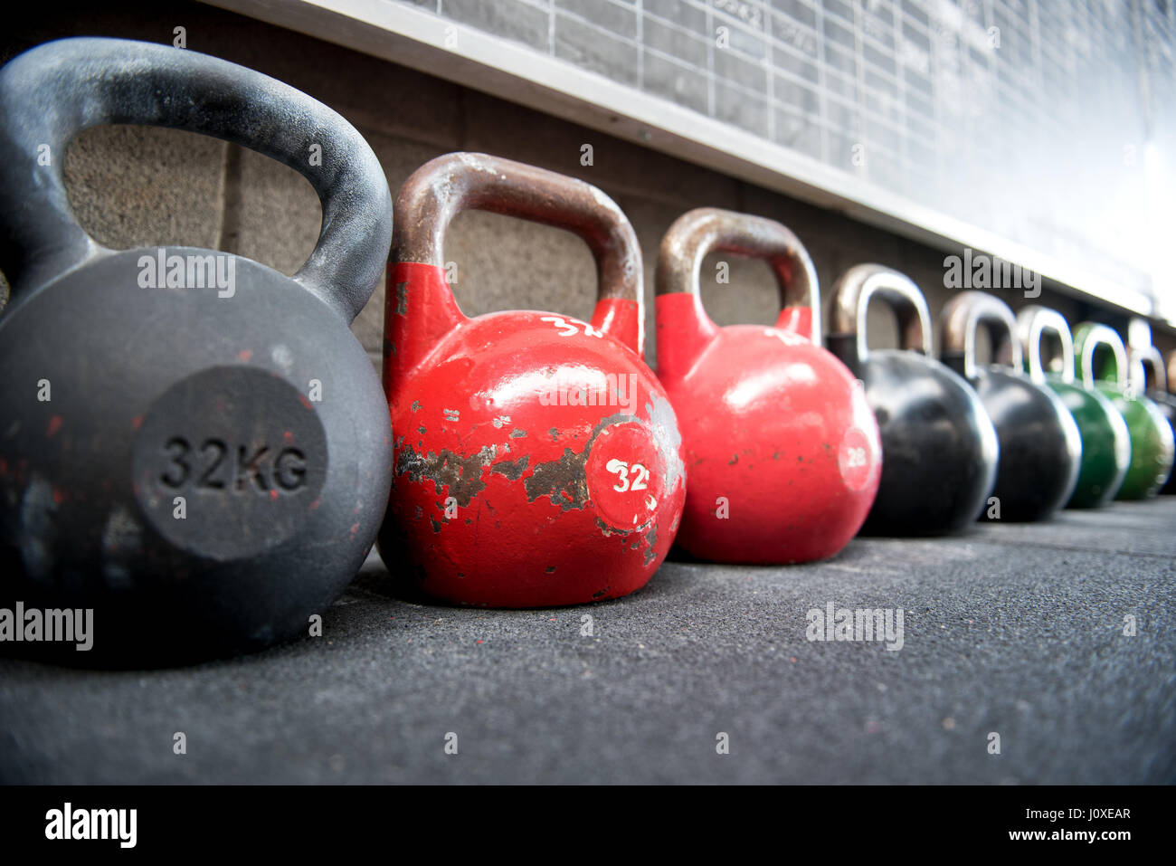 Long row of kettlebell weights in a gym with focus to a pair of colorful red 32 kg weights in a concept of exercise, fitness and hea Stock Photo - Alamy