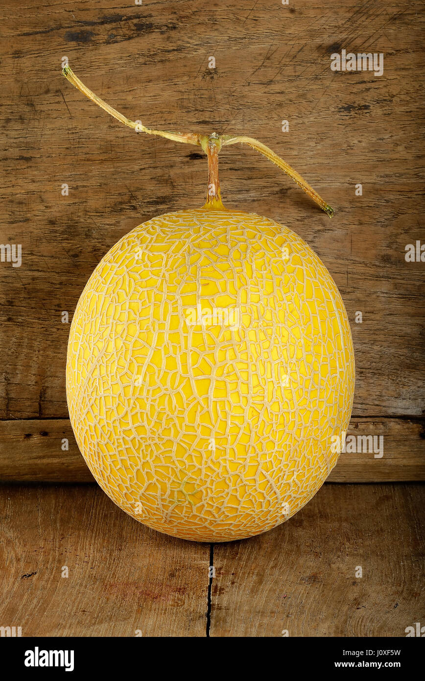 Yellow cantaloupe melon on the wooden background Stock Photo Alamy